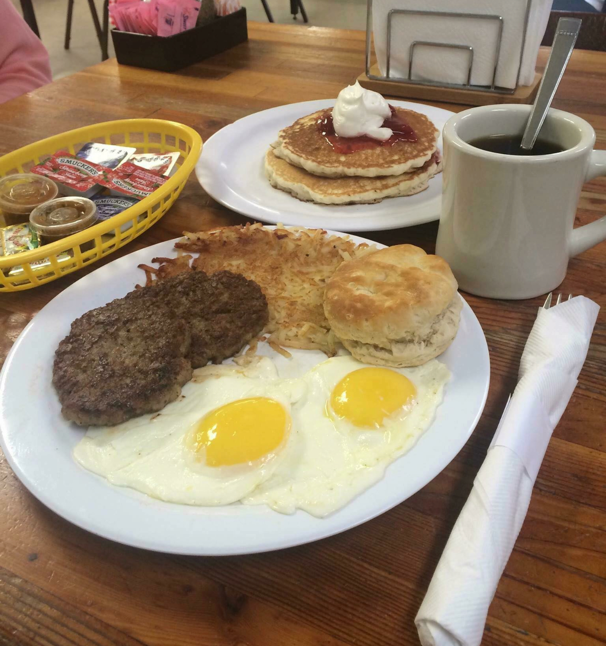 Country breakfast platter with eggs, sausage, hash browns, biscuit, and pancakes at Jack's Cafe